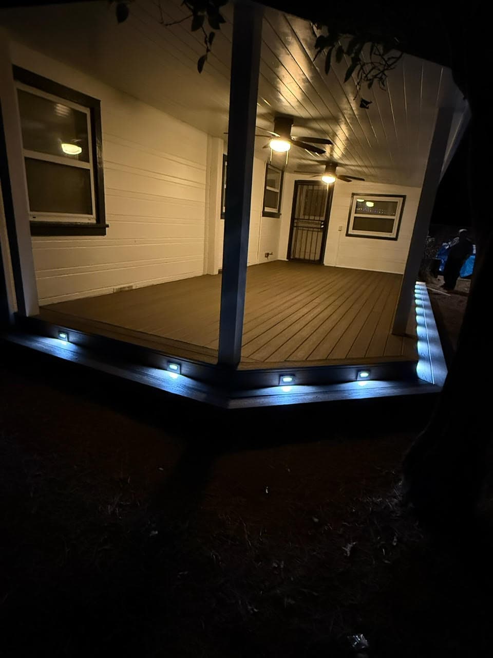 Custom backyard deck construction with wood railing