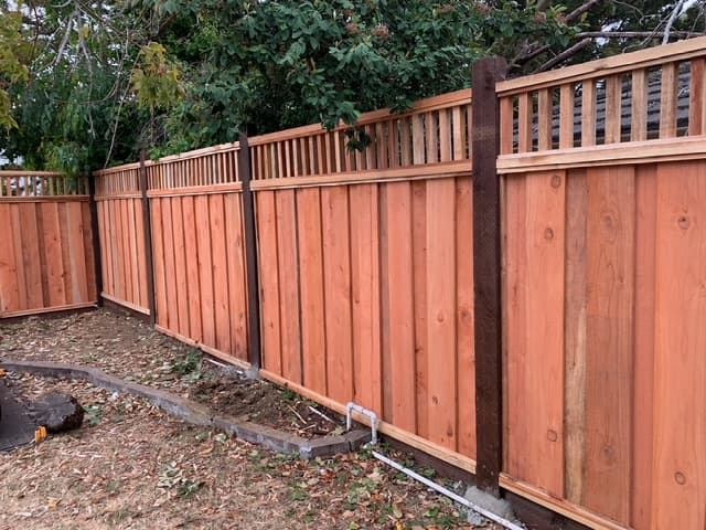 Newly installed wood fence along property line